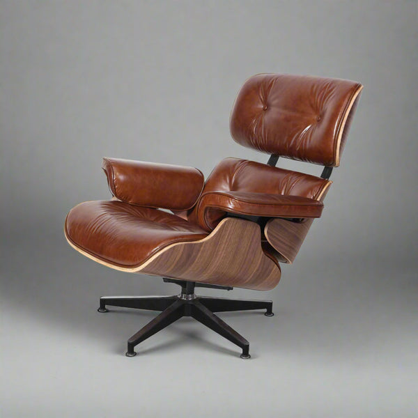 Brown leather lounge chair with wooden armrests on a white background